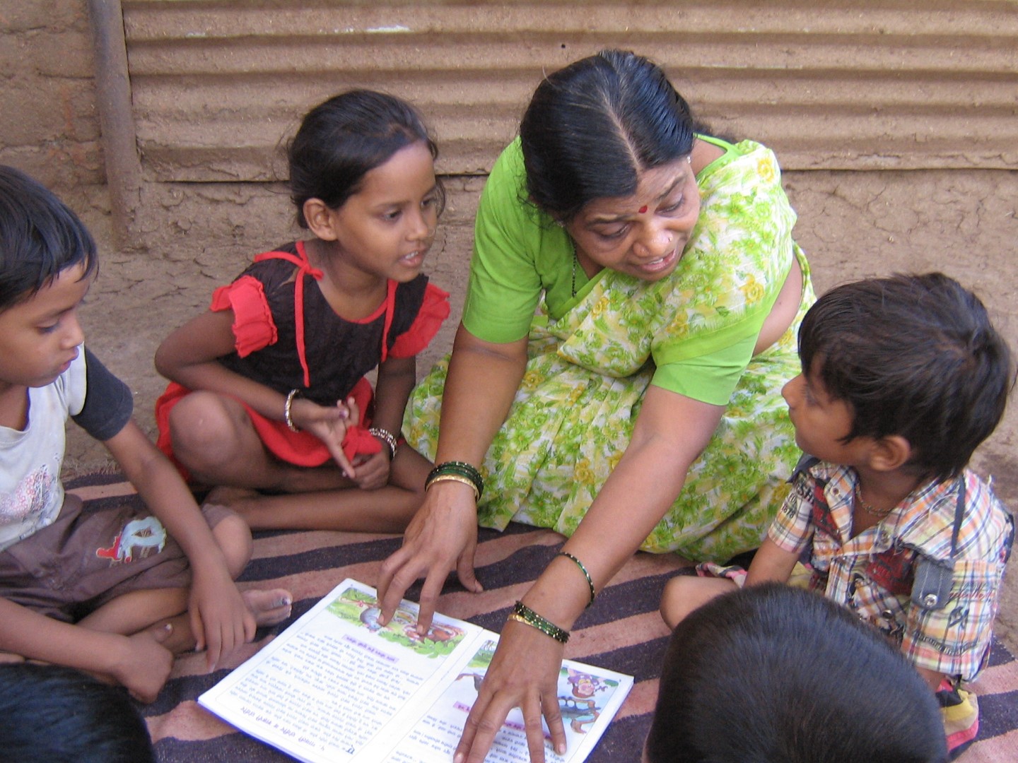 A Nachiket staff member reading to children