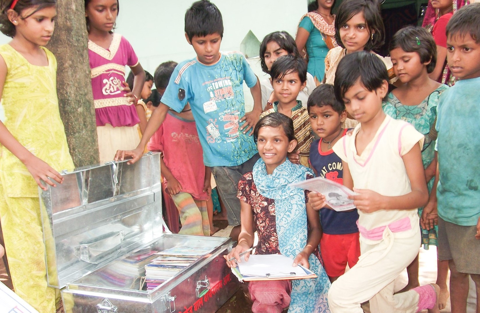 Children receiving new reading materials at Nachiket